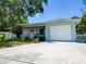 Charming single-story home with attached garage, walkway, and well-maintained landscaping at 5600 Hobson Ne St, St Petersburg, FL 33703