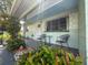 Inviting front porch with seating, decorative plants and a view of the well-maintained yard at 5600 Hobson Ne St, St Petersburg, FL 33703