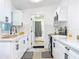 Well-lit kitchen with white cabinets and black hardware and faucet at 5600 Hobson Ne St, St Petersburg, FL 33703