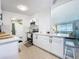 Modern kitchen with stainless steel appliances, white cabinets, and quartz countertops at 5600 Hobson Ne St, St Petersburg, FL 33703