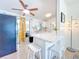 Modern white kitchen featuring breakfast bar, white cabinets, and stainless appliances at 5600 Hobson Ne St, St Petersburg, FL 33703