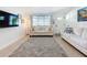 Bright living room with large windows, neutral color scheme, comfortable seating, and a stylish area rug at 5600 Hobson Ne St, St Petersburg, FL 33703