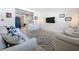 Cozy living room with open access to the kitchen and modern lighting at 5600 Hobson Ne St, St Petersburg, FL 33703