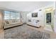 Bright and airy living room featuring neutral decor, large windows, and easy access to the front door and hall at 5600 Hobson Ne St, St Petersburg, FL 33703
