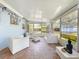 Sunroom featuring tiled floors, white patio furniture, and lots of windows at 5600 Hobson Ne St, St Petersburg, FL 33703