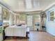 Enclosed sunroom with tile floors, neutral walls and trim, a ceiling fan, and a farmhouse dining table at 5600 Hobson Ne St, St Petersburg, FL 33703