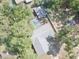 Aerial view of a home with a private pool and fenced yard surrounded by mature trees at 5614 Kenny Dr, Tampa, FL 33617