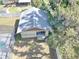 Aerial view of a home and its detached garage, along with a private pool surrounded by a fenced yard at 5614 Kenny Dr, Tampa, FL 33617