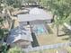 Aerial view of a fenced in home with a screened in pool and detached garage at 5614 Kenny Dr, Tampa, FL 33617