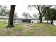 A spacious, fenced backyard features a screened pool and a cozy fire pit area at 5614 Kenny Dr, Tampa, FL 33617