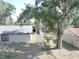 View of a backyard with mature trees and a private fence at 5614 Kenny Dr, Tampa, FL 33617