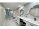 Bathroom with dual vanities and a glass-enclosed shower at 5614 Kenny Dr, Tampa, FL 33617