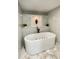 Soaking tub with marble backsplash and modern black faucet at 5614 Kenny Dr, Tampa, FL 33617