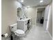 Bright bathroom featuring double sinks, elegant mirrors, and a glimpse into a serene bedroom space at 5614 Kenny Dr, Tampa, FL 33617