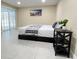 Minimalist bedroom with tile flooring and sliding glass doors to the outside at 5614 Kenny Dr, Tampa, FL 33617