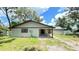 Charming single-story home featuring a covered entry, mature trees, and a well-maintained lawn at 5614 Kenny Dr, Tampa, FL 33617