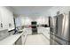 Bright kitchen with white cabinets, stainless steel appliances, and tile flooring at 5614 Kenny Dr, Tampa, FL 33617