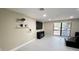 Well-lit living area with large window and a wall-mounted TV at 5614 Kenny Dr, Tampa, FL 33617
