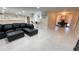 Open living area includes bar seating, desk and black sectional couch at 5614 Kenny Dr, Tampa, FL 33617