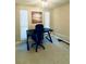 Home office featuring a modern black desk, ergonomic chair, tile floors, and natural light from two windows at 5614 Kenny Dr, Tampa, FL 33617