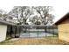 Backyard oasis with a screened-in pool and hot tub, perfect for relaxing and entertaining guests at 5614 Kenny Dr, Tampa, FL 33617