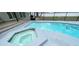 Backyard showcasing a sparkling pool and hot tub combination with a concrete deck at 5614 Kenny Dr, Tampa, FL 33617