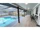 Screened-in pool area featuring a spacious covered patio and outdoor seating, ideal for entertaining and relaxing at 5614 Kenny Dr, Tampa, FL 33617