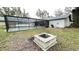 Screened-in pool area with an outdoor fire pit for relaxed outdoor living and backyard enjoyment at 5614 Kenny Dr, Tampa, FL 33617
