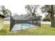 Large in-ground screened pool with attached spa offers the perfect backyard escape at 5614 Kenny Dr, Tampa, FL 33617
