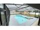 Enjoy this pristine screened pool area with attached spa, perfect for outdoor entertaining at 5614 Kenny Dr, Tampa, FL 33617