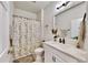 Bathroom with a floral shower curtain, quartz countertop vanity, and neutral color scheme at 5645 Del Coronado Dr, Apollo Beach, FL 33572
