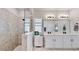 Modern bathroom featuring a glass enclosed shower, double vanity, and linen closet for storage at 5645 Del Coronado Dr, Apollo Beach, FL 33572