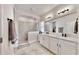 Bathroom featuring a glass walk-in shower, double vanity, and modern fixtures at 5645 Del Coronado Dr, Apollo Beach, FL 33572