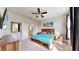 Cozy primary bedroom with a comfortable bed, neutral carpet, and natural light streaming through the windows at 5645 Del Coronado Dr, Apollo Beach, FL 33572