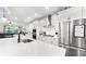 Modern kitchen featuring stainless steel appliances, a center island, and views into the living room at 5645 Del Coronado Dr, Apollo Beach, FL 33572