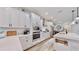 Bright kitchen with white cabinets, stainless steel appliances, and an island with a breakfast bar at 5645 Del Coronado Dr, Apollo Beach, FL 33572