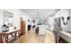 Open concept area featuring wood floors, island seating, and modern fixtures at 5645 Del Coronado Dr, Apollo Beach, FL 33572