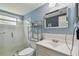 Bright bathroom features a glass enclosed shower and a white vanity with storage at 5728 14Th N Ave # 101B, St Petersburg, FL 33710