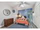 Comfortable bedroom with blue accent wall features wood-look floors and a full-sized bed at 5728 14Th N Ave # 101B, St Petersburg, FL 33710