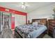 Cozy bedroom with a large bed and grey accents; features a red accent wall with white trim at 5728 14Th N Ave # 101B, St Petersburg, FL 33710