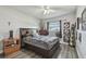 Cozy bedroom with a large bed and grey accents; features a ceiling fan and window with bright daylight at 5728 14Th N Ave # 101B, St Petersburg, FL 33710