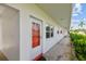 Condo entrance with red door, sidelight, and walkway at 5728 14Th N Ave # 101B, St Petersburg, FL 33710