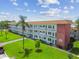 Three-story condo with balconies, well-manicured lawns, and mature landscaping creates curb appeal at 5728 14Th N Ave # 101B, St Petersburg, FL 33710