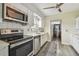 White kitchen featuring modern appliances and ample counter space at 5728 14Th N Ave # 101B, St Petersburg, FL 33710
