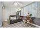 Comfortable living room featuring a power reclining sofa, sleek flooring and light from the front windows at 5728 14Th N Ave # 101B, St Petersburg, FL 33710