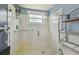 Bright shower features a glass door, white tiling, and chrome fixtures at 5728 14Th N Ave # 101B, St Petersburg, FL 33710