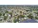 Expansive aerial view showcasing a neighborhood with mature trees and various home styles, near a commercial area at 5961 36Th Ave N, St Petersburg, FL 33710
