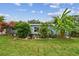 Well-manicured lawn and vibrant tropical landscaping enhance this home's outdoor appeal at 5961 36Th Ave N, St Petersburg, FL 33710