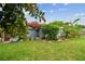 Lush backyard featuring a variety of tropical plants and a cozy seating area at 5961 36Th Ave N, St Petersburg, FL 33710