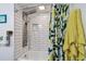 Updated bathroom featuring white subway tile in shower and leafy shower curtain at 5961 36Th Ave N, St Petersburg, FL 33710